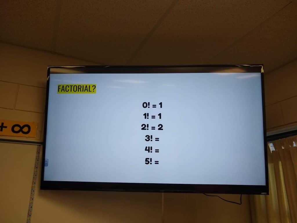 factorial introduction slide on tv screen in math classroom. 