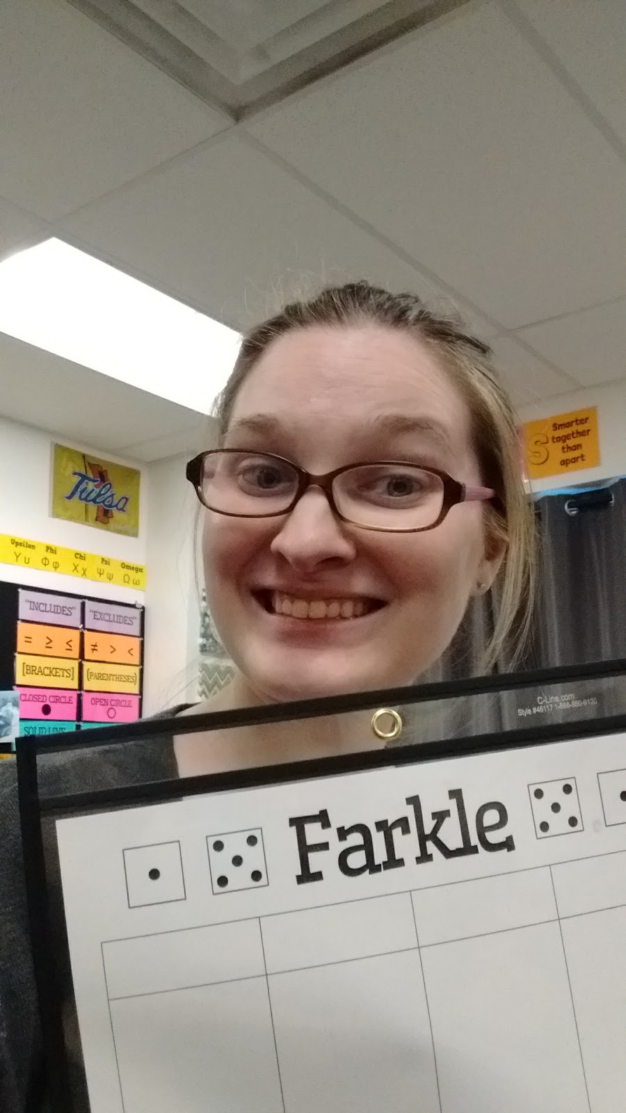 girl holding farkle score sheet in dry erase pocket. 