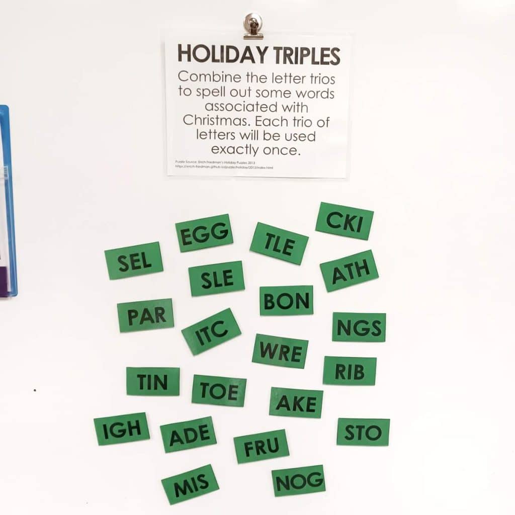holiday triples word puzzle hanging on dry erase board in classroom 