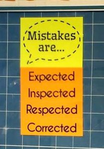 Mistakes are Expected, Inspected, Respected, Corrected Poster hanging in high school math classroom.