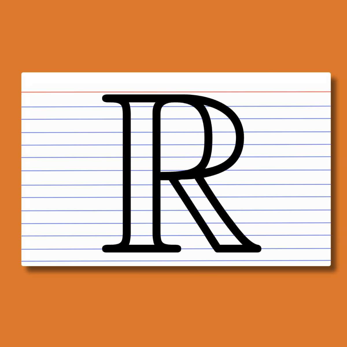 real number symbol on top of index card on orange background